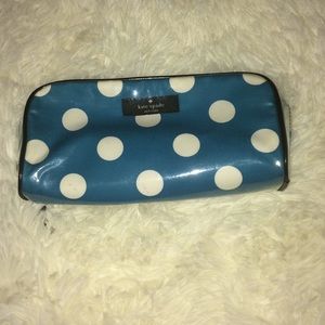 A Kate Spade cosmetic , makeup type bag